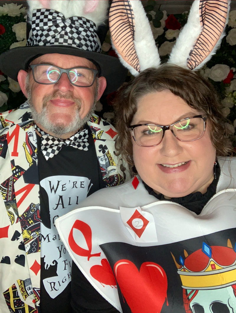 a man and woman dressed in costume as the Mad Hatter and White Rabbit