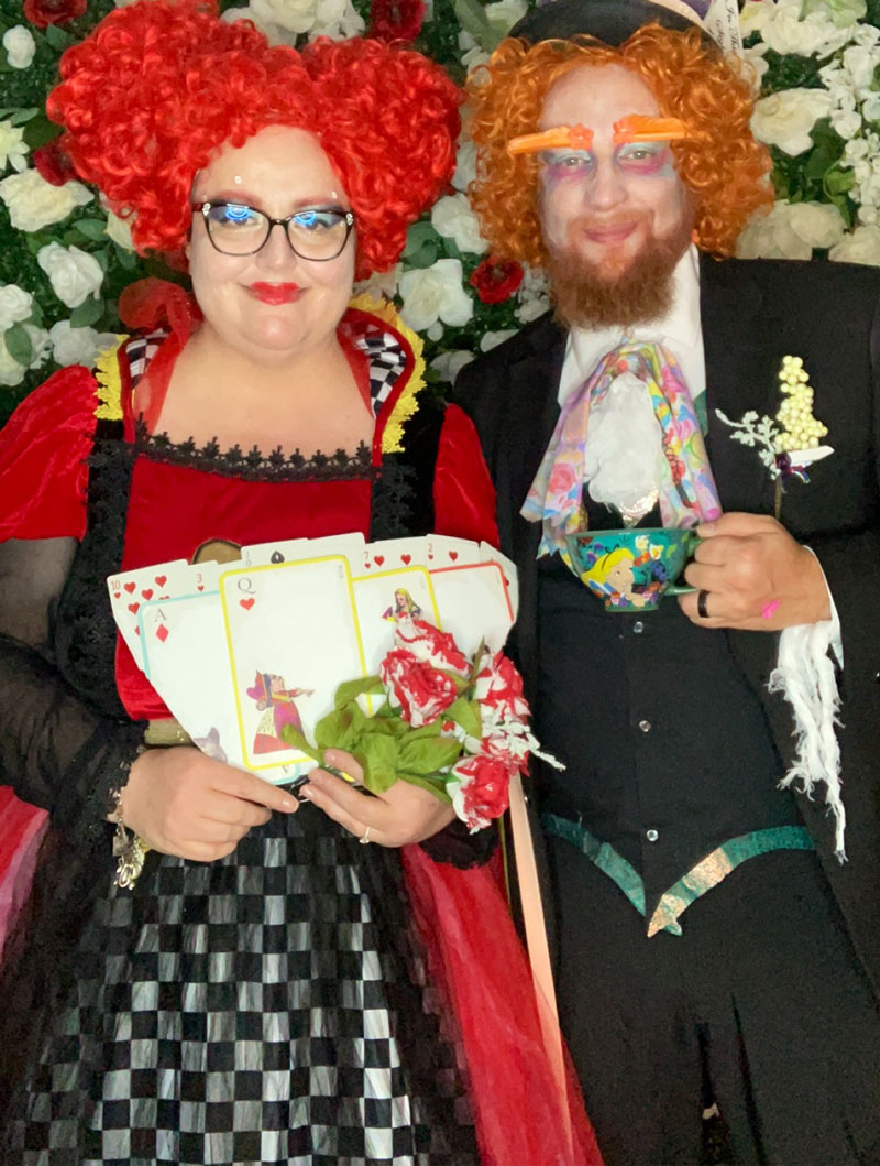 a man and woman dressed in costume as the Mad Hatter and Queen of Hearts