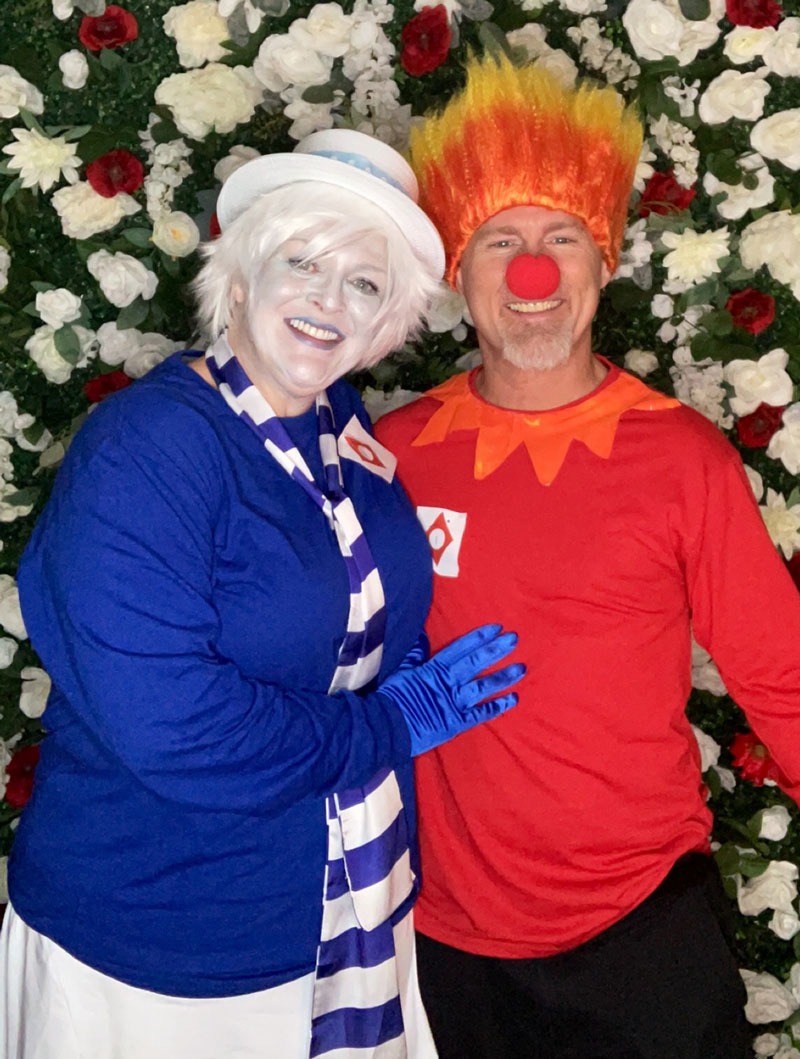 a man and woman dressed in costume as the Miser Brothers