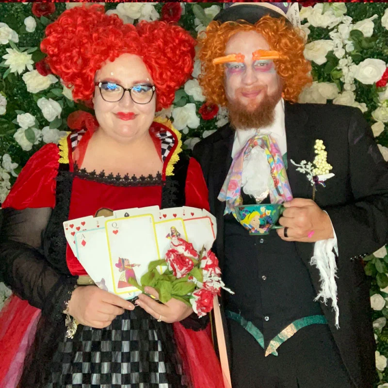Man and woman dressed as the Queen of Hearts and Mad Hatter