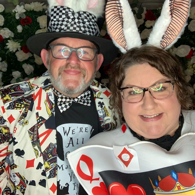 Couple, male and female, dressed as the mad hatter and a playing card with rabbit ears
